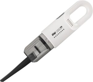 Aspirador de pó portátil de mão WAP Handson branco, compacto e sem fio, sendo carregado por indução.